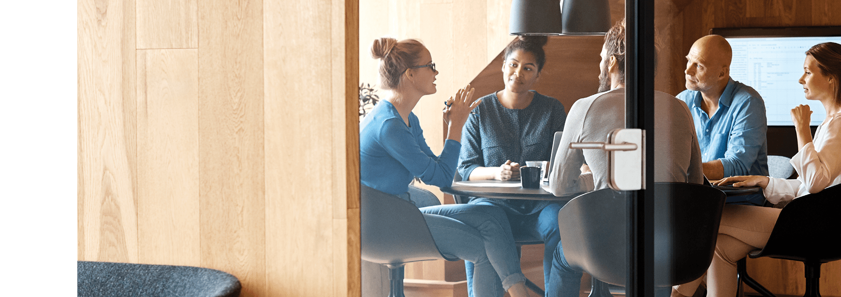 Group of people having a discussion in a conference room.