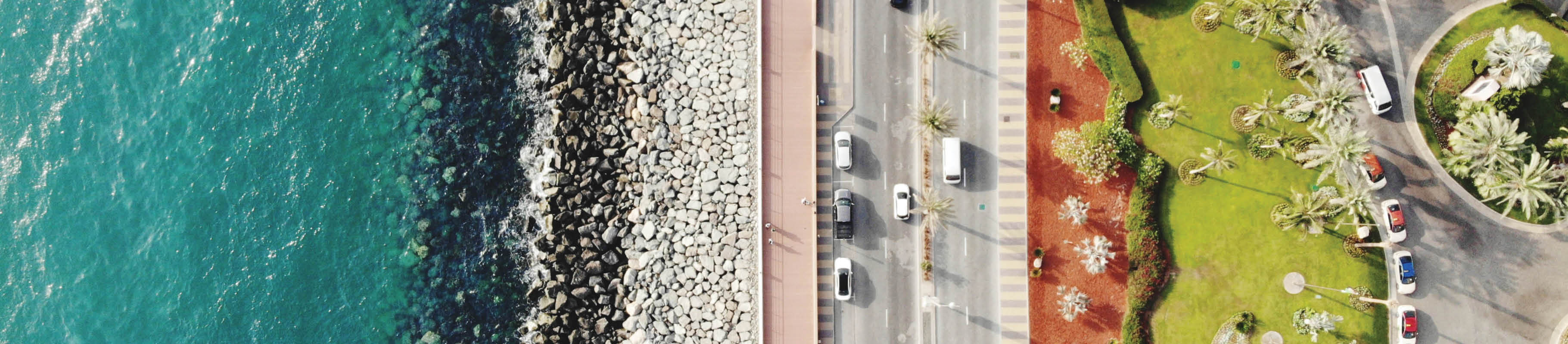 Image of aerial view of water, road and grassy area. 
