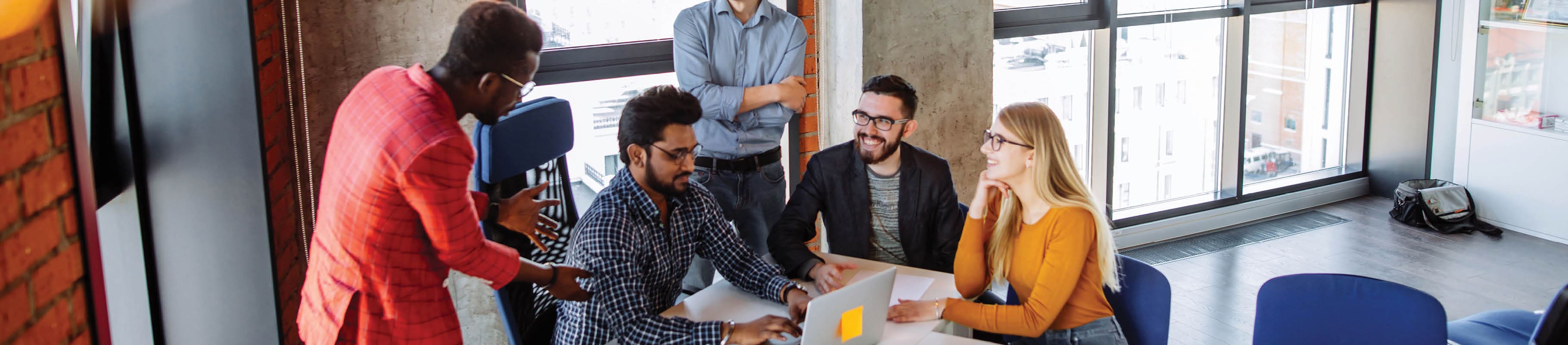 Smiling young professionals in office setting. 
