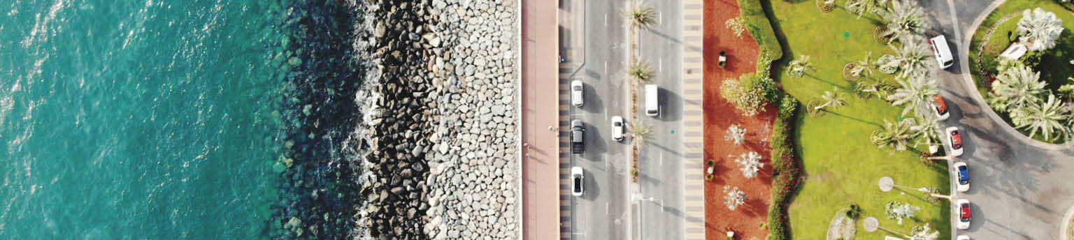 Image of aerial view of water, road and grassy area. 