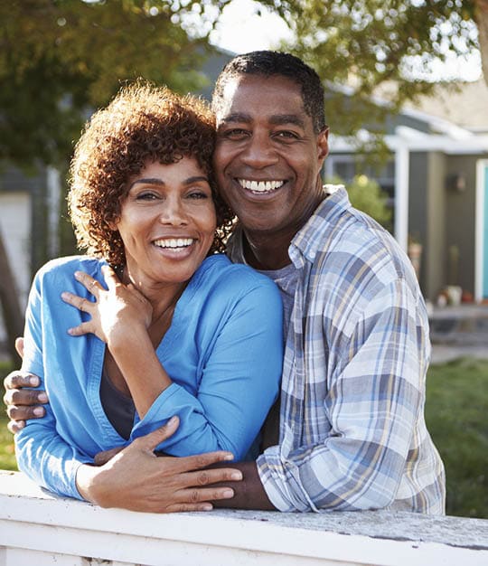 Image of older, happy couple, embracing.
