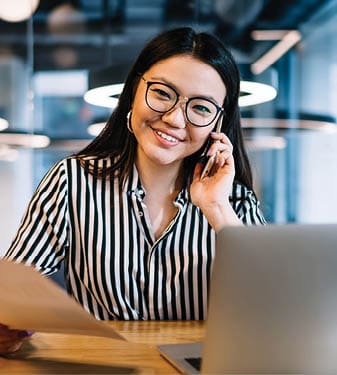 A young Asian woman is talking on a phone