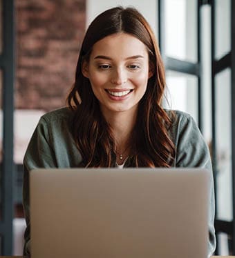 A young woman is working on a laptop