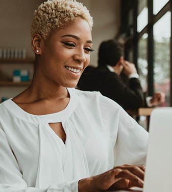 An African American woman is working on a laptop computer