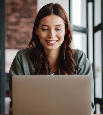A young woman is working on a laptop