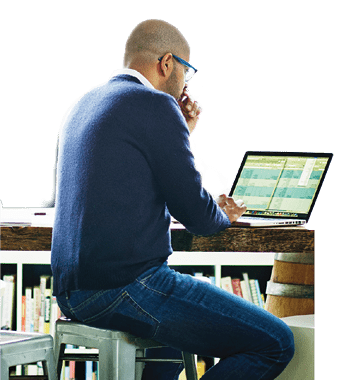 A businessman is working at a laptop.