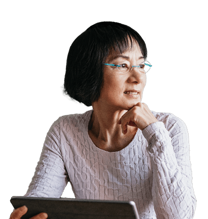 A middle-aged Asian woman is holding an electronic tablet.