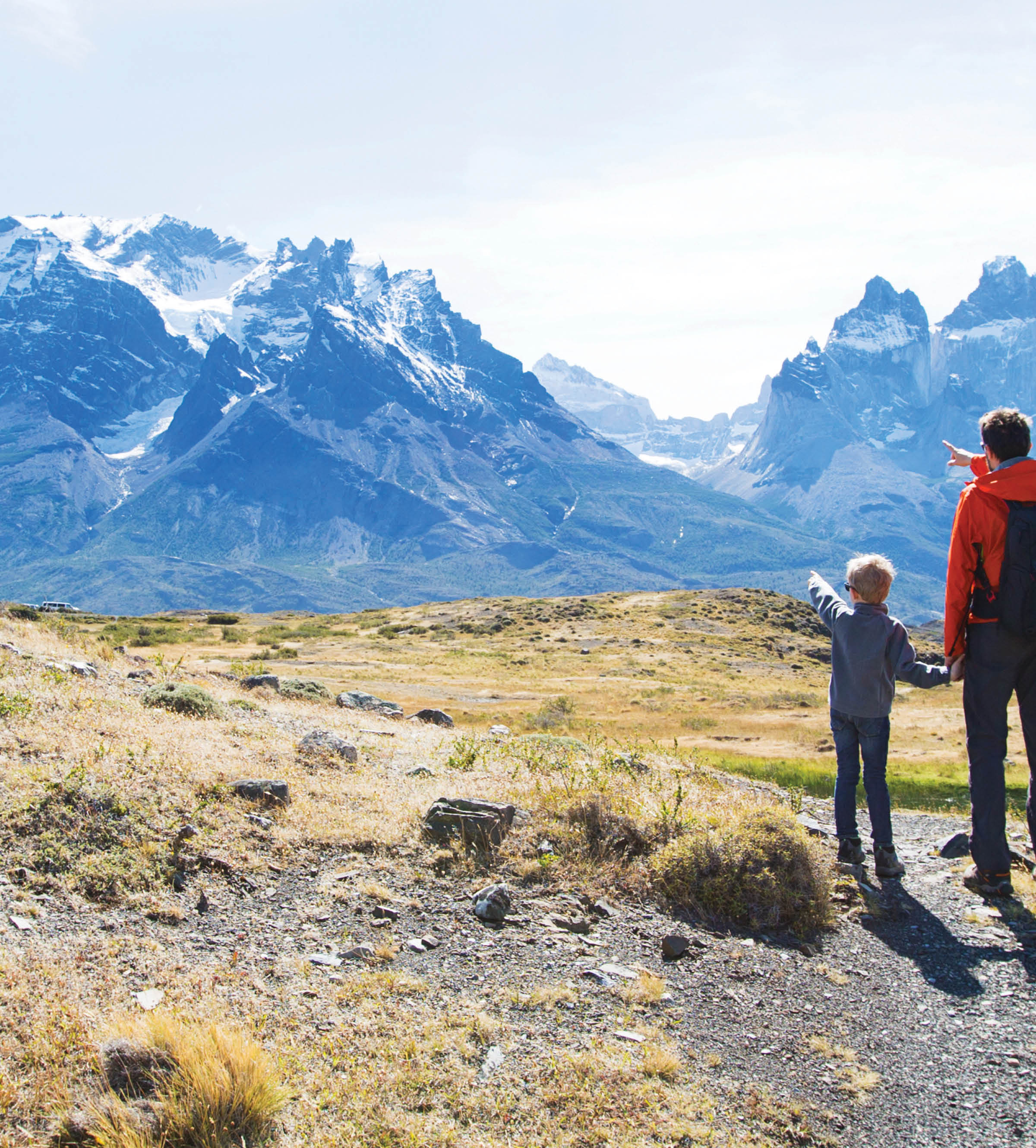 Father and son hiking and pointing at distant mountains
