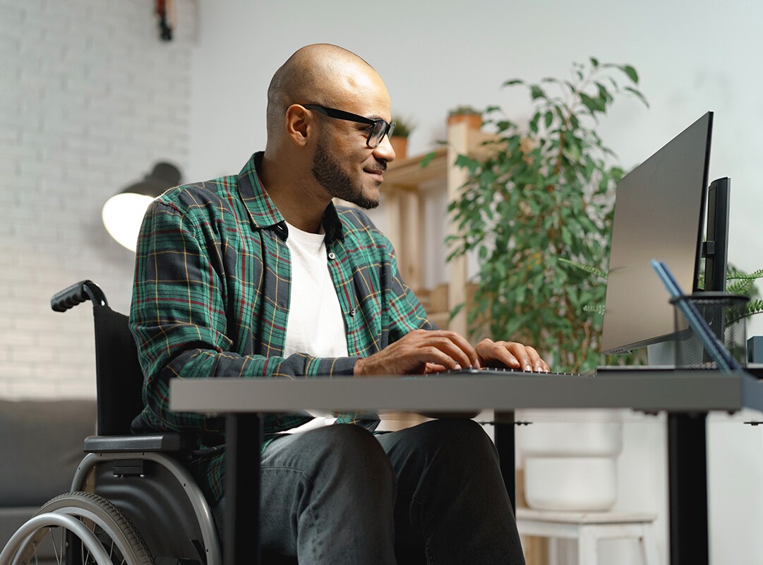 Man in wheelchair working on a computer