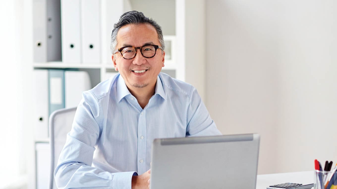 smiling businessman with laptop