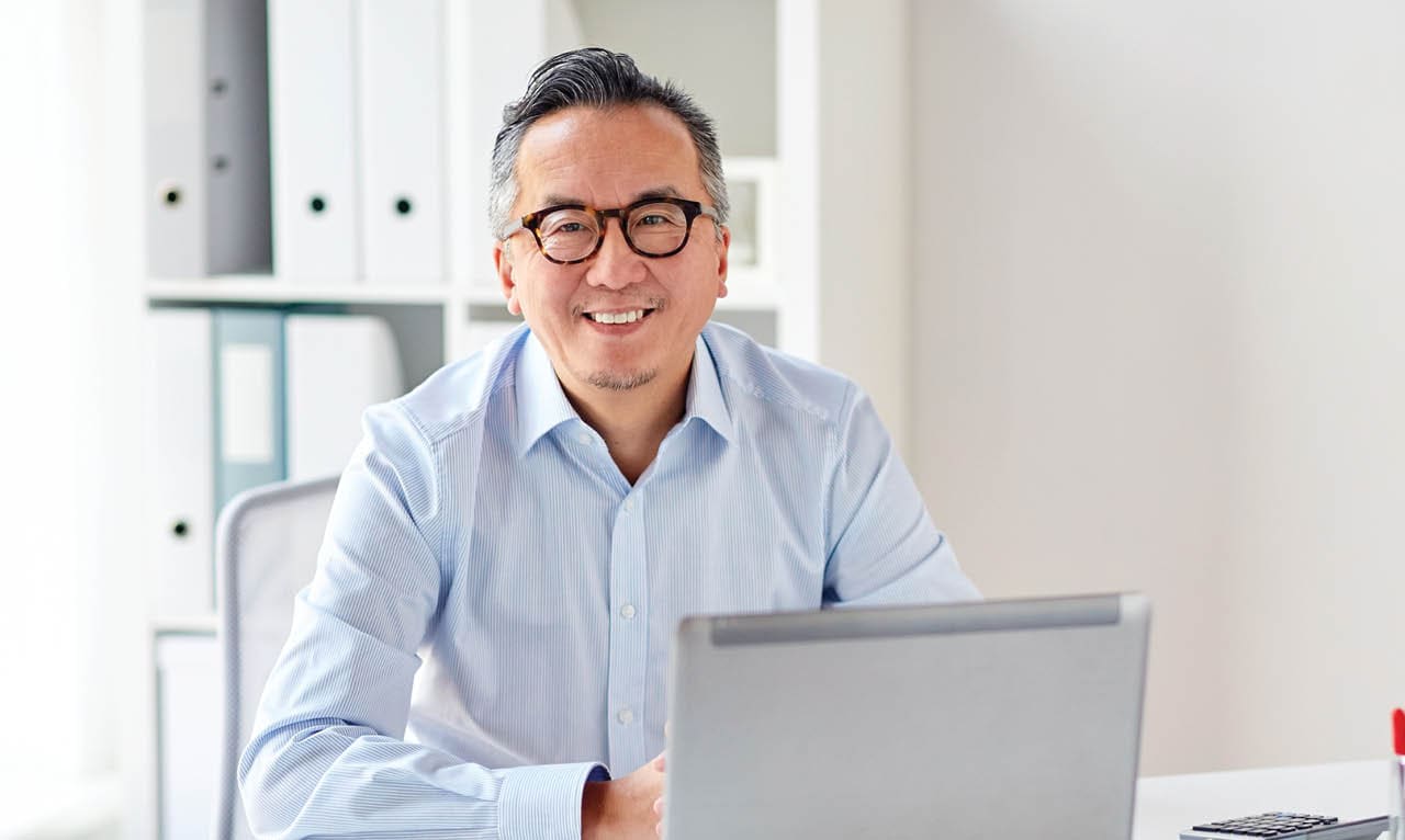 smiling businessman with laptop