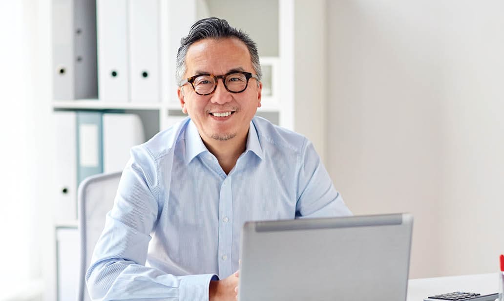 smiling businessman with laptop